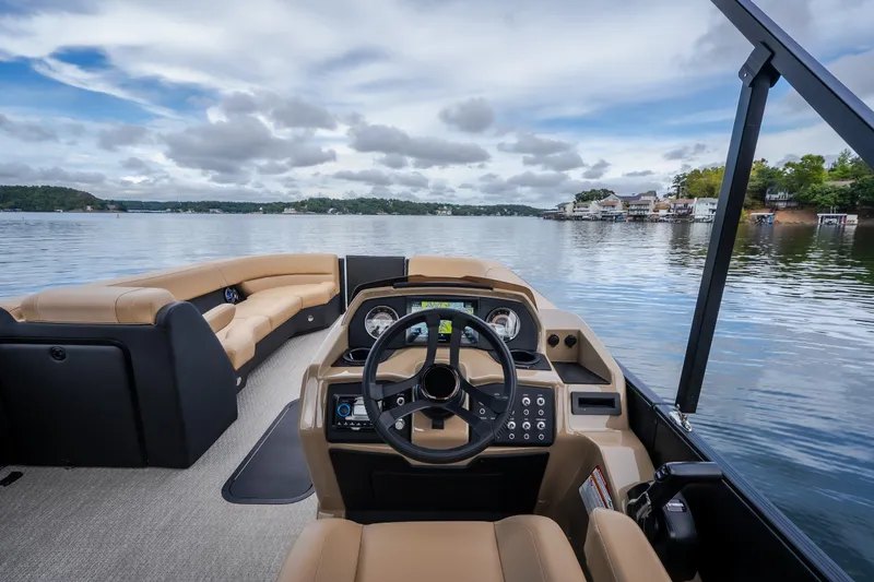 Slide: The Image of Interior view of 2026 Evotti 525QL boat, featuring luxurious seating and modern dashboard on a serene lake. - 33