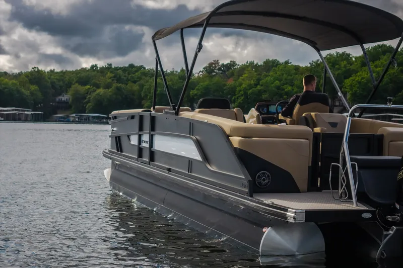 Slide: The Image of 2026 Evotti 525QL pontoon boat cruising on a scenic lake under cloudy skies. - 79
