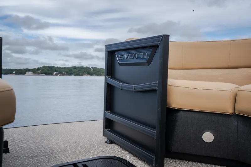 Slide: The Image of Evotti 525QL 2026 boat interior with beige seating, overlooking a serene lake. - 16