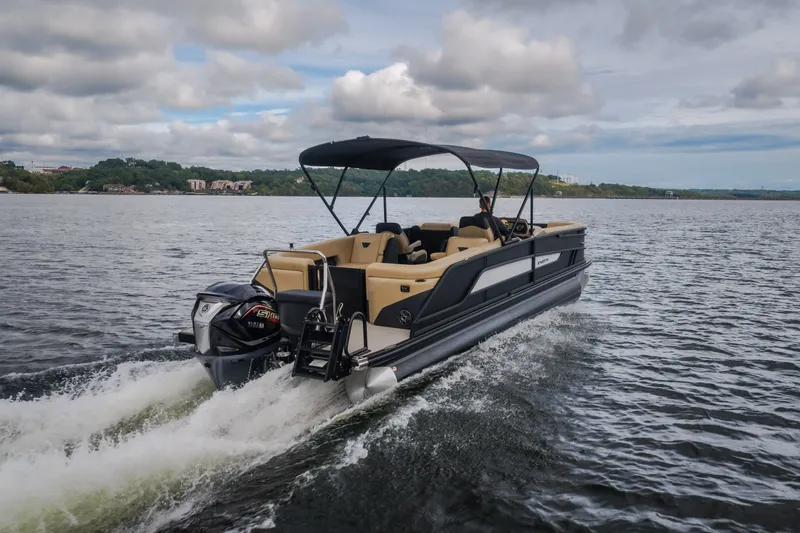 Slide: The Image of 2026 Evotti 525QL pontoon boat cruising on a lake under cloudy skies. - 69