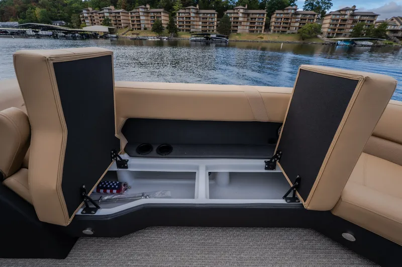 Slide: The Image of Open storage compartment on Evotti 525QL boat, 2026 model, with scenic waterfront view. - 29
