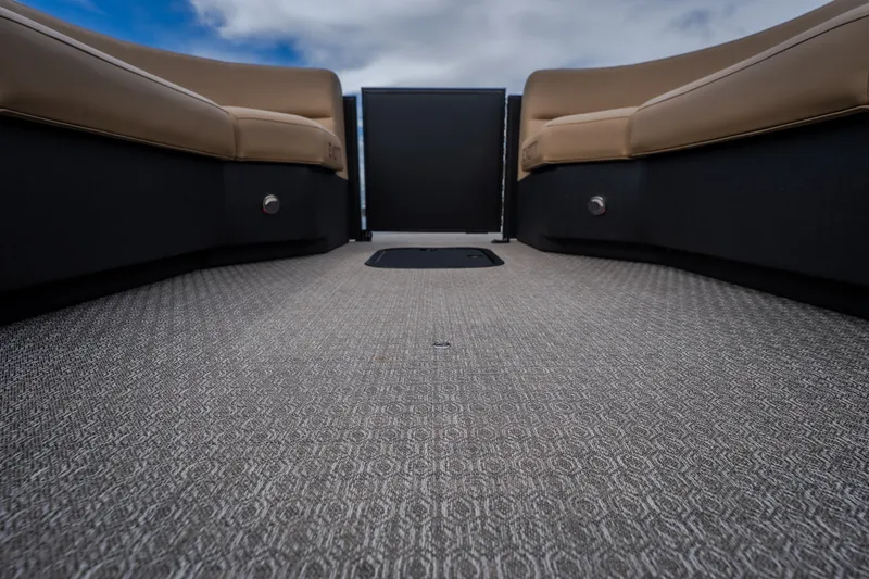 Slide: The Image of Interior view of 2026 Evotti 525QL boat with beige seating and patterned flooring. - 28
