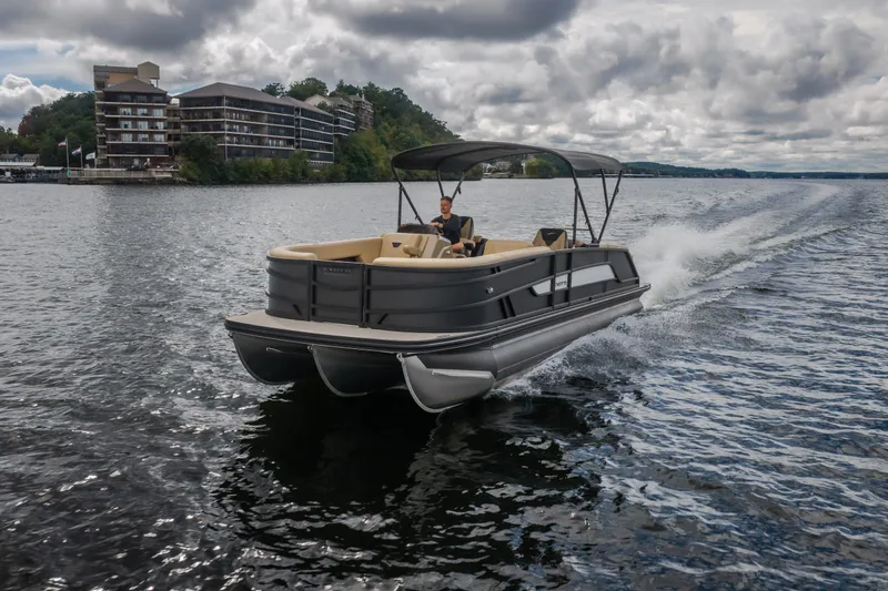Slide: The Image of Evotti 525QL 2026 pontoon boat cruising on a lake with scenic background. - 67