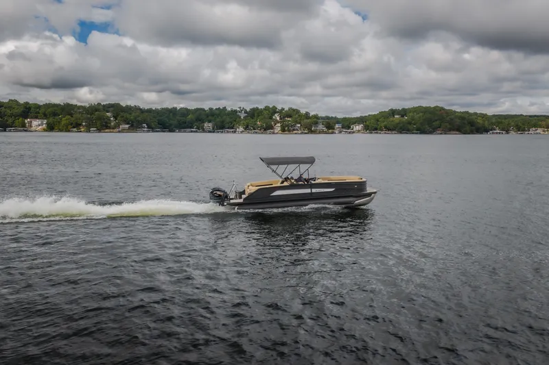 Slide: The Image of 2026 Evotti 525QL pontoon boat cruising on a lake under cloudy skies. - 64