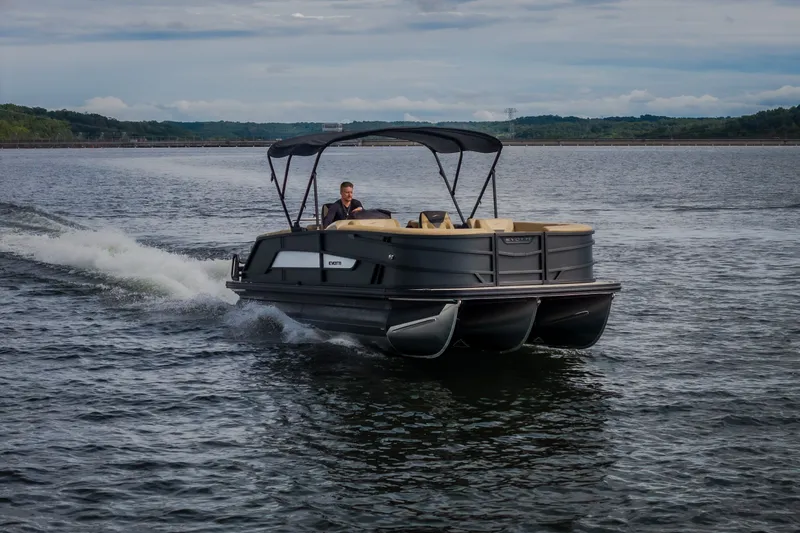 Slide: The Image of 2026 Evotti 525QL pontoon boat cruising on a scenic lake. - 74