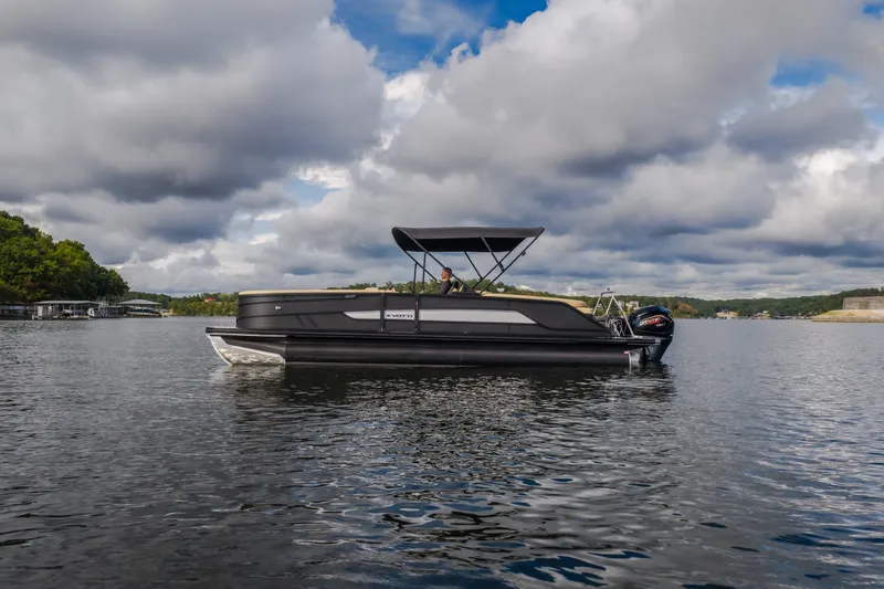 The Image of 2026 Evotti 525QL pontoon boat on a serene lake under cloudy skies. - 2