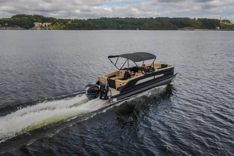 Slide: The Image of 2026 Evotti 525QL pontoon boat cruising on a scenic lake under cloudy skies. - 70