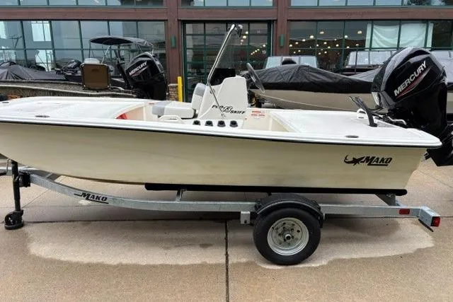 The Image of 2025 Mako Pro Skiff 13 CC boat on trailer, featuring Mercury outboard motor. - 1