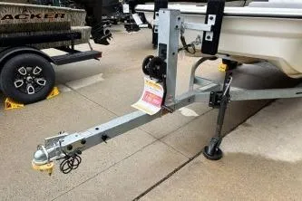 Slide: The Image of 2025 Mako Pro Skiff 13 CC boat trailer parked on concrete surface. - 12