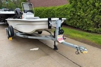 Slide: The Image of 2025 Mako Pro Skiff 13 CC boat on trailer, parked on driveway. - 4
