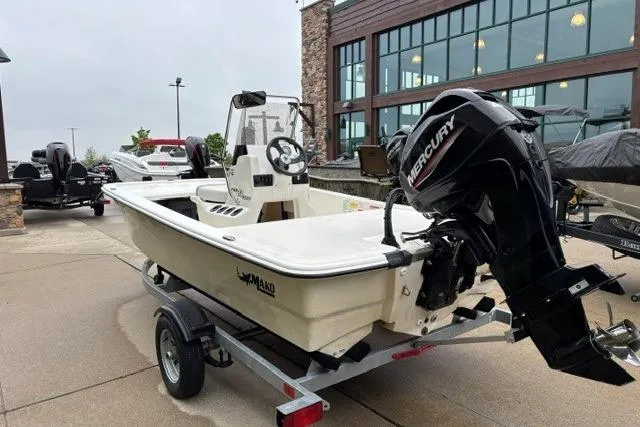 Slide: The Image of 2025 Mako Pro Skiff 13 CC boat with Mercury engine on trailer. - 5