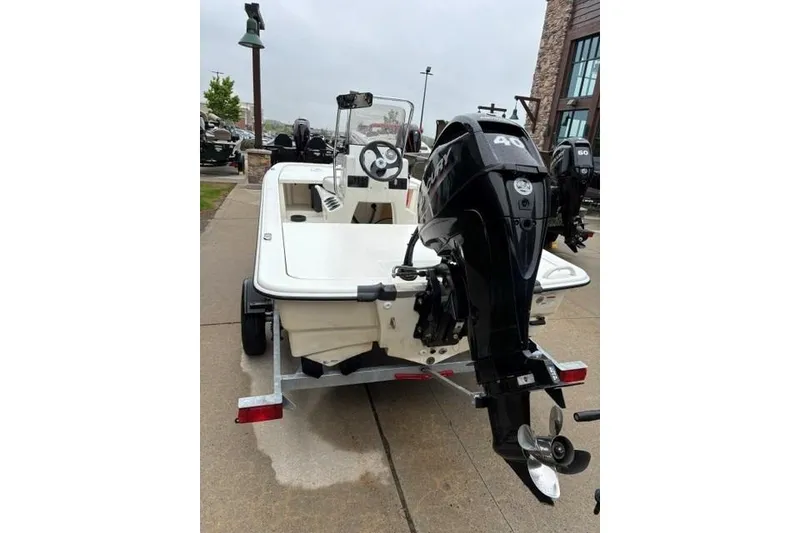 Slide: The Image of 2025 Mako Pro Skiff 13 CC boat on trailer, featuring a powerful outboard motor. - 6