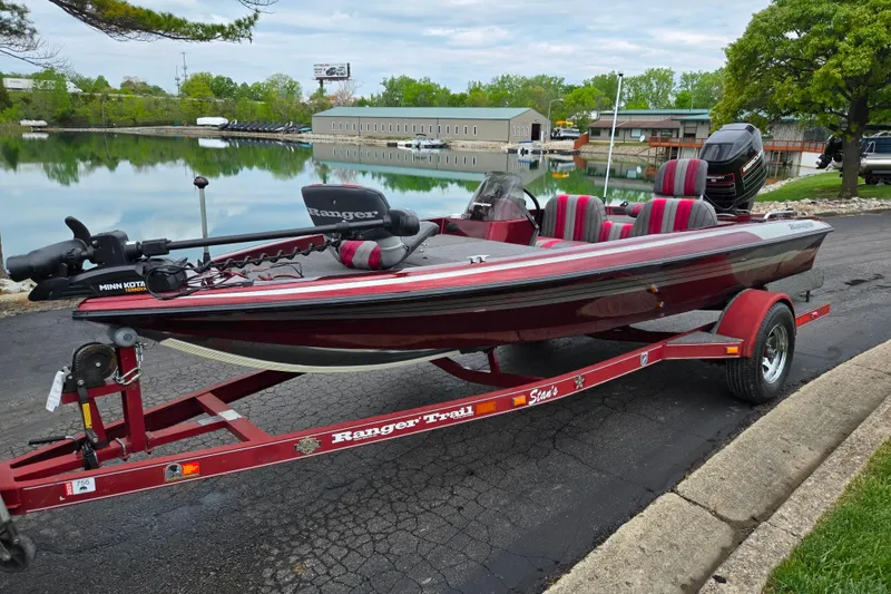 Slide: The Image of 1995 Ranger R72 Sport boat on trailer by a serene lakeside. - 10