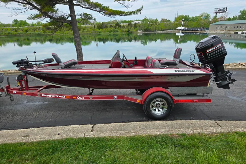 Slide: The Image of 1995 Ranger R72 Sport boat on trailer by a serene lake. - 11