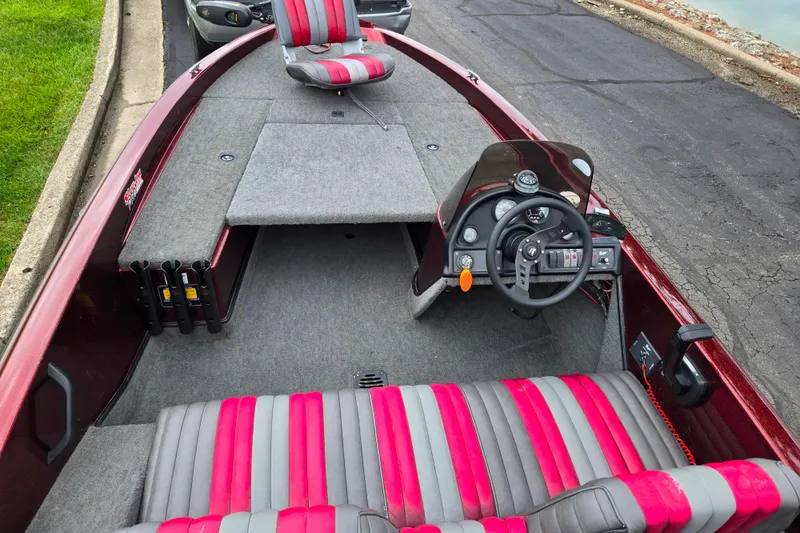 Slide: The Image of 1995 Ranger R72 Sport boat interior with red and gray seating, steering wheel, and dashboard controls. - 12