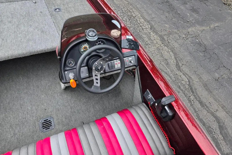 Slide: The Image of Interior of a 1995 Ranger R72 Sport boat with steering wheel and dashboard controls. - 13