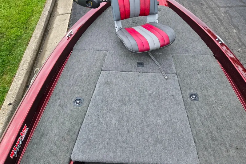 Slide: The Image of 1995 Ranger R72 Sport boat deck with red and gray seat, carpeted surface. - 14