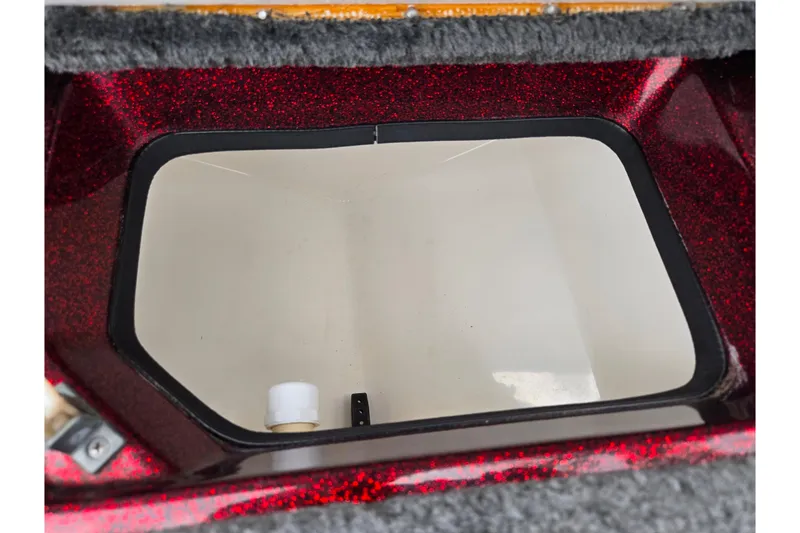 Slide: The Image of Open storage compartment in 1995 Ranger R72 Sport boat with red glitter finish. - 17