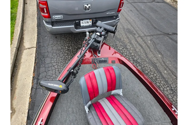 Slide: The Image of 1995 Ranger R72 Sport boat with red and gray seating, parked behind a truck. - 19