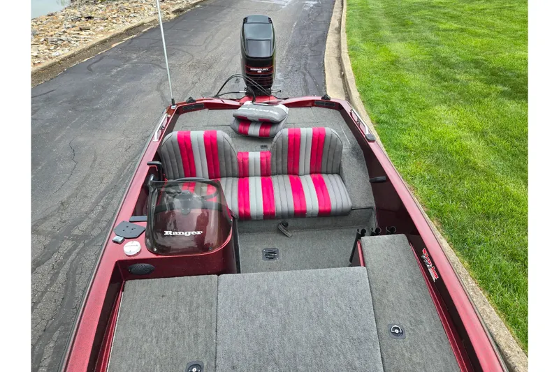 Slide: The Image of 1995 Ranger R72 Sport boat with red and gray interior, parked on a paved road. - 20