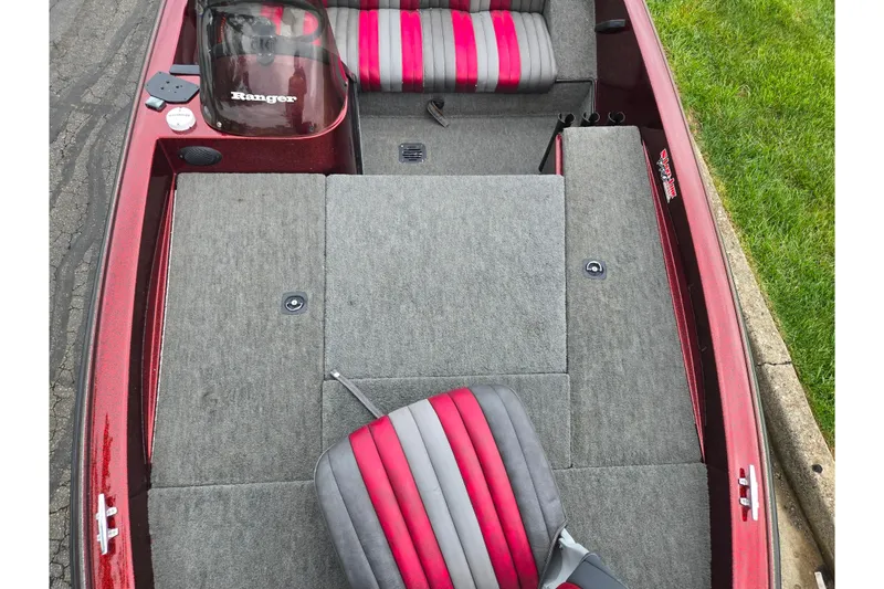 Slide: The Image of 1995 Ranger R72 Sport boat interior with red and gray seating, carpeted deck. - 21