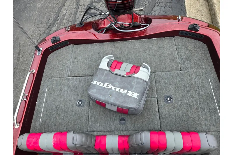 Slide: The Image of 1995 Ranger R72 Sport boat interior with red and gray seating and carpeted deck. - 23