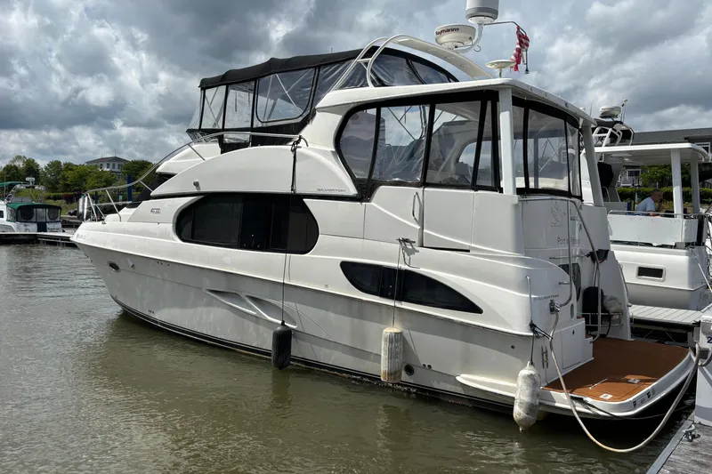 The Image of 2007 Silverton 43 Motor Yacht docked under cloudy skies. - 0