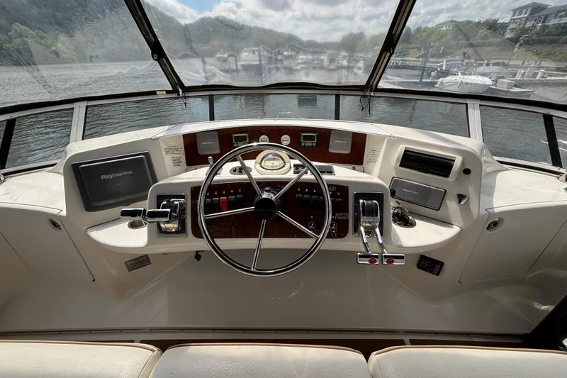 Slide: The Image of 2007 Silverton 43 Motor Yacht helm with steering wheel and navigation controls. - 11