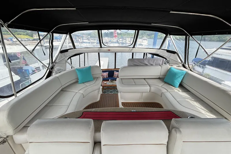 Slide: The Image of Luxurious interior of a 2007 Silverton 43 Motor Yacht with white seating and blue cushions. - 12