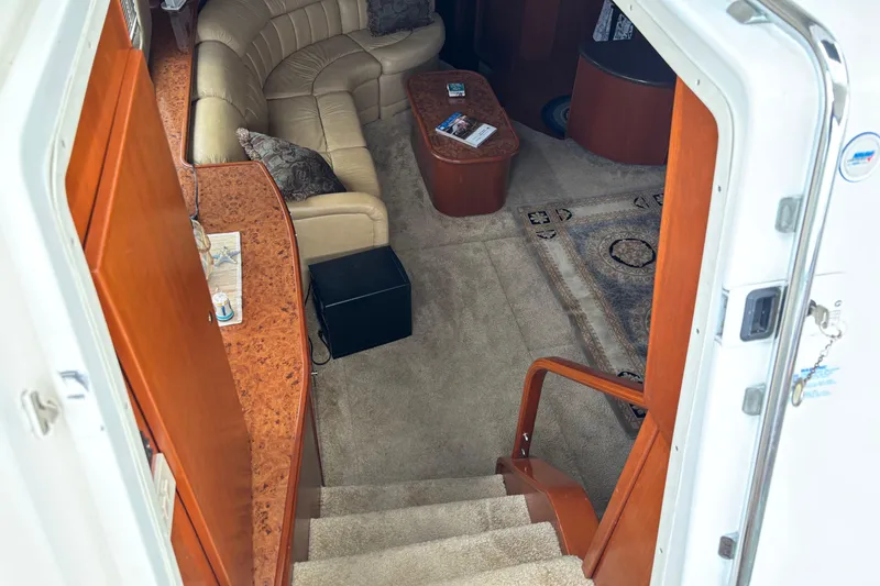 Slide: The Image of Interior view of 2007 Silverton 43 Motor Yacht with beige seating and wooden accents. - 13