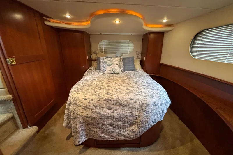 Slide: The Image of Luxurious bedroom interior of 2007 Silverton 43 Motor Yacht with elegant wood finishes. - 19