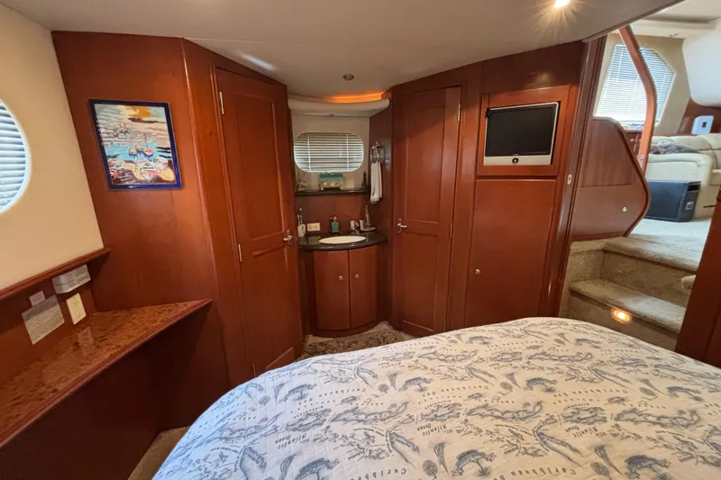 Slide: The Image of Interior of 2007 Silverton 43 Motor Yacht with wood cabinetry and cozy furnishings. - 20