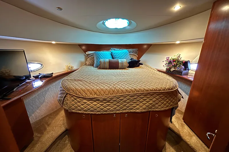 Slide: The Image of Luxurious bedroom interior of 2007 Silverton 43 Motor Yacht with cozy bedding and elegant decor. - 23