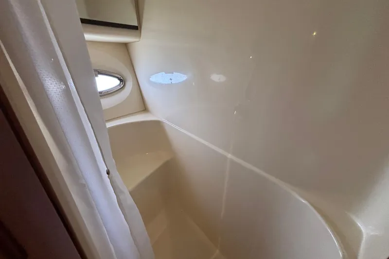 Slide: The Image of Bathroom interior of 2007 Silverton 43 Motor Yacht with porthole and shower curtain. - 25
