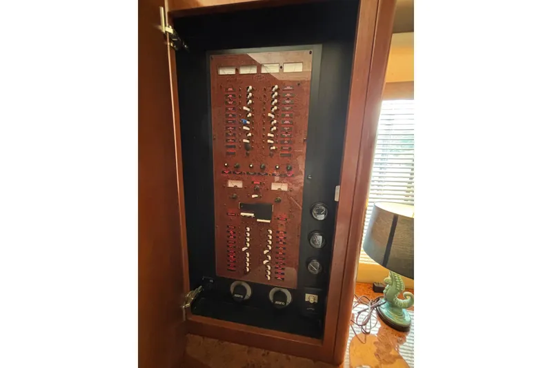 Slide: The Image of Electrical panel inside 2007 Silverton 43 Motor Yacht, featuring switches and gauges. - 26