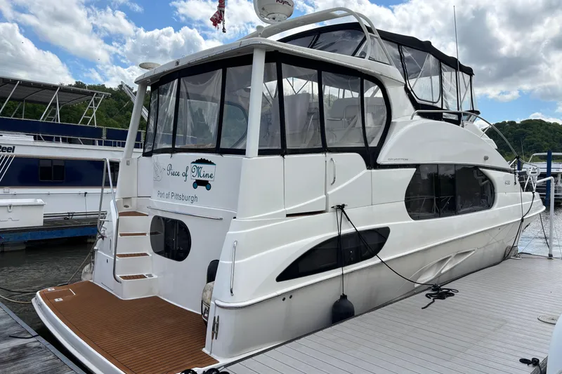 Slide: The Image of 2007 Silverton 43 Motor Yacht docked, featuring sleek design and spacious deck area. - 3