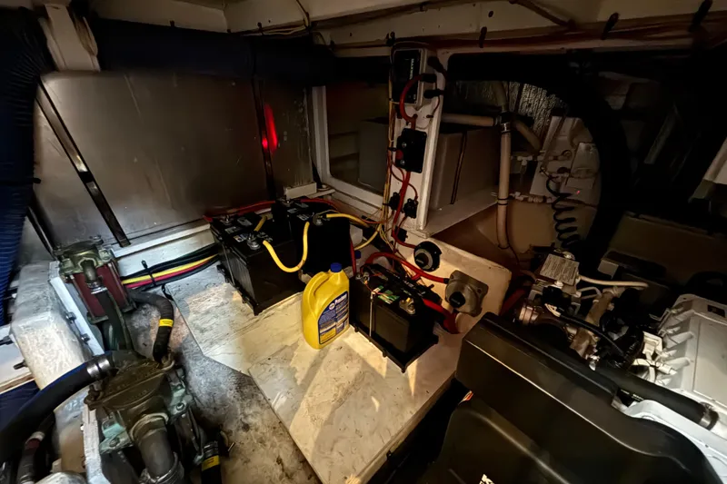 Slide: The Image of Engine room of 2007 Silverton 43 Motor Yacht with batteries and maintenance equipment. - 32