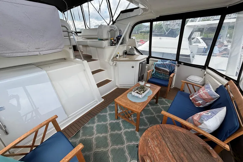 Slide: The Image of Luxurious 2007 Silverton 43 Motor Yacht interior with cozy seating and elegant decor. - 6