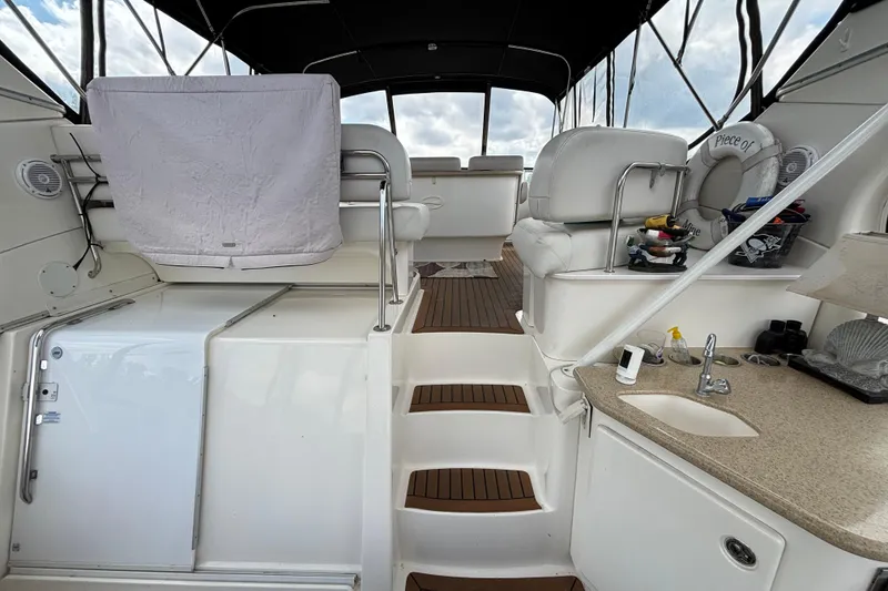 Slide: The Image of 2007 Silverton 43 Motor Yacht interior with seating, sink, and wooden flooring. - 8