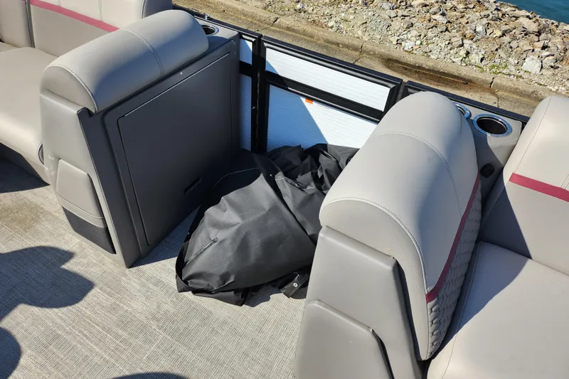 Slide: The Image of 2024 Qwest Angler Qwest XRE boat interior with gray seating and storage area. - 13