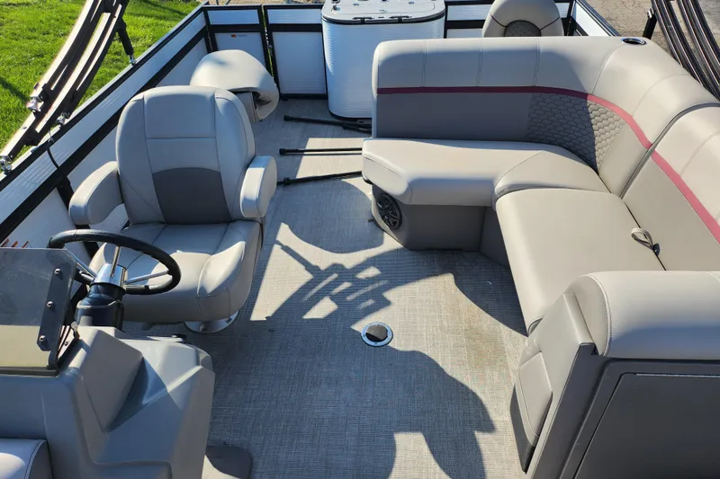 Slide: The Image of 2024 Qwest Angler Qwest XRE boat interior with plush seating and steering console. - 14