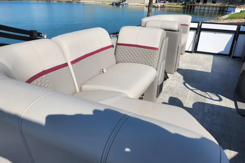 Slide: The Image of 2024 Qwest Angler Qwest XRE boat interior with beige seating and red accents. - 20