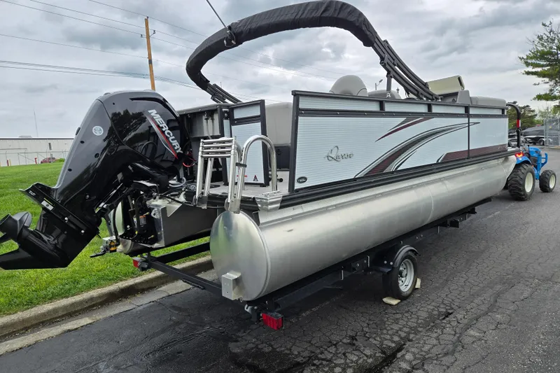 Slide: The Image of 2024 Qwest Angler Qwest XRE pontoon boat with Mercury outboard motor on trailer. - 3