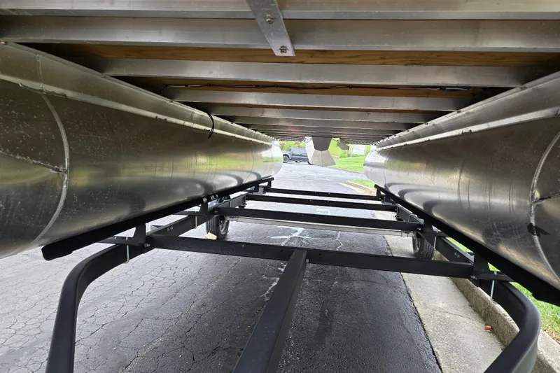 Slide: The Image of Underneath view of 2024 Qwest Angler Qwest XRE pontoon boat on trailer. - 7