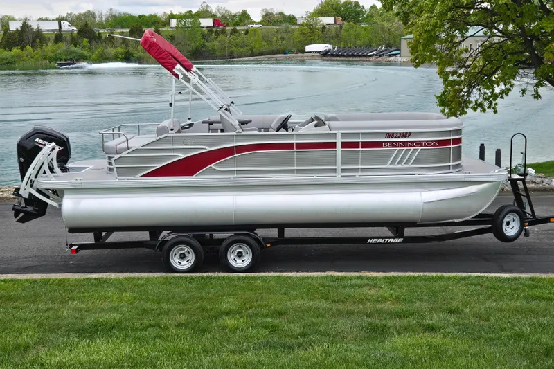 The Image of 2023 Bennington 22 LSB pontoon boat on trailer by a scenic lake. - 0