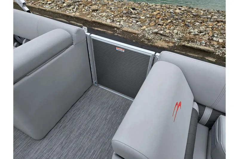 Slide: The Image of 2023 Bennington 22 LSB boat interior with gray seating and textured flooring. - 12