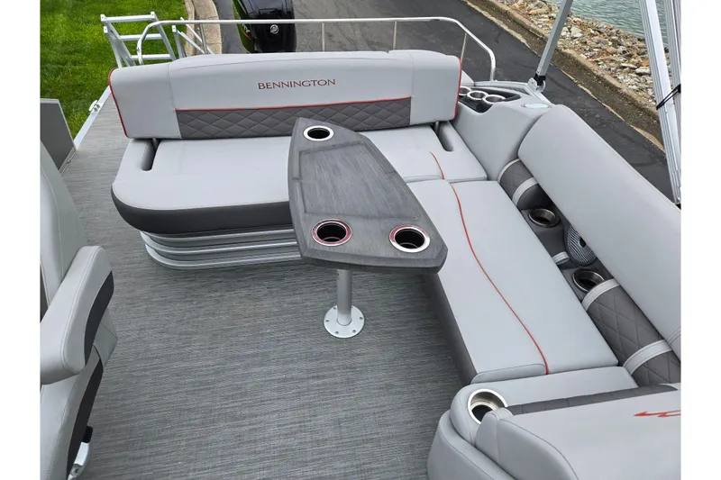 Slide: The Image of 2023 Bennington 22 LSB boat interior with gray seating and a central table. - 14