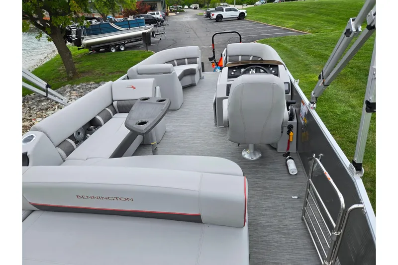Slide: The Image of 2023 Bennington 22 LSB pontoon boat interior with plush seating and modern helm. - 19