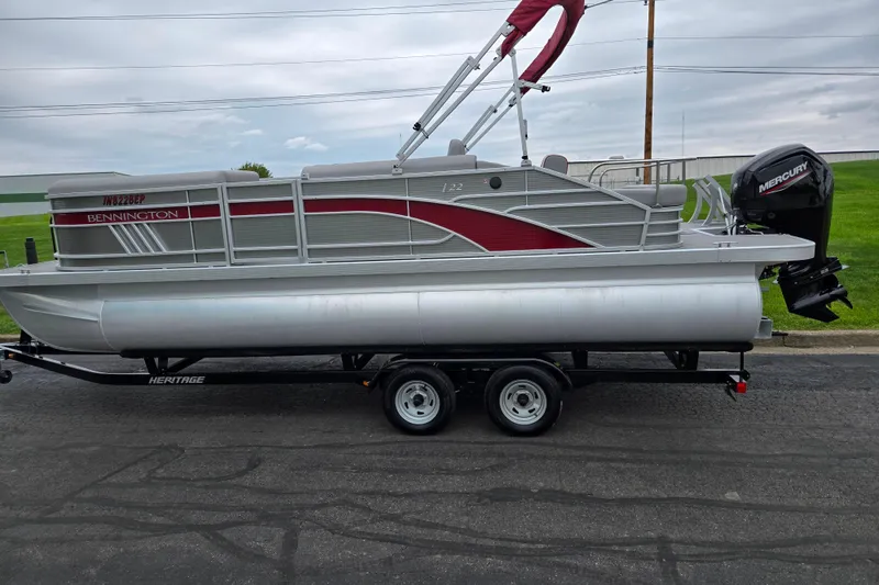 Slide: The Image of 2023 Bennington 22 LSB pontoon boat on trailer with Mercury outboard motor. - 4