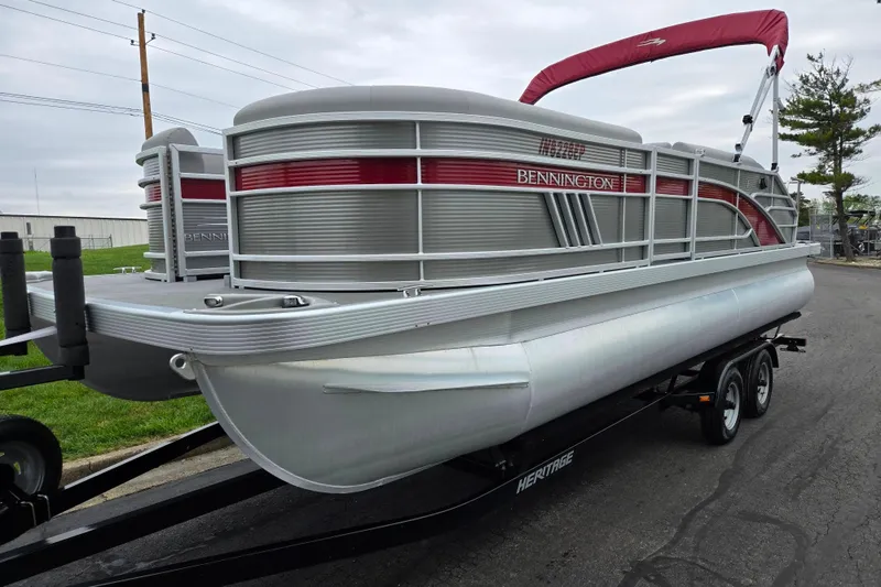 Slide: The Image of 2023 Bennington 22 LSB pontoon boat on trailer, featuring sleek design and red accents. - 5
